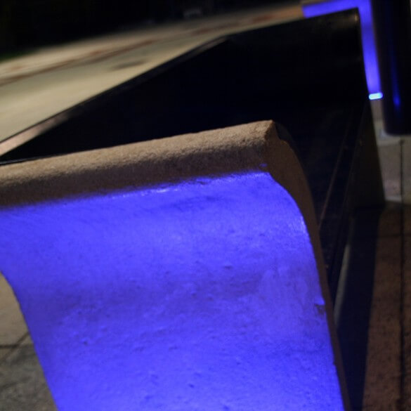 exterior bench being lit by spotlights
