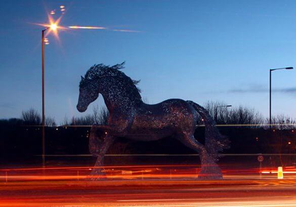 sculpture of a galloping horse on a roundabout