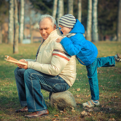old man with young child in the park
