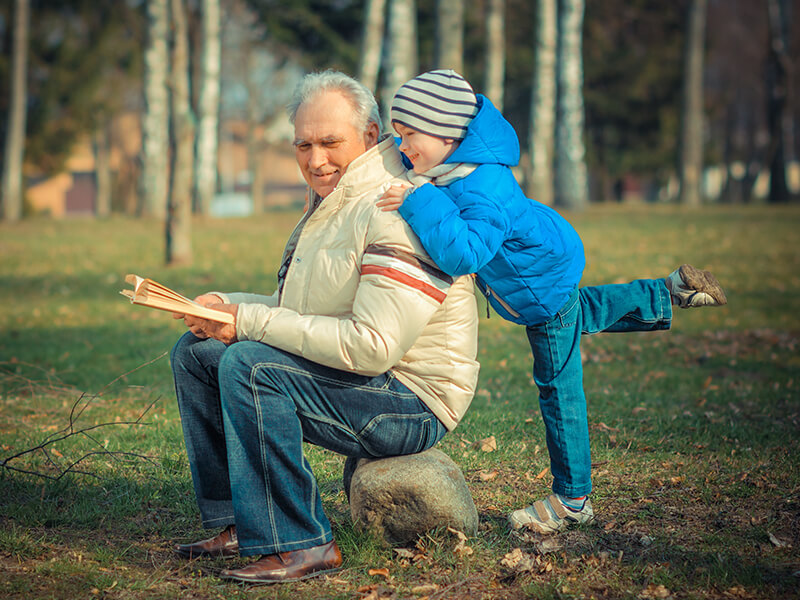 old man with young child in the park