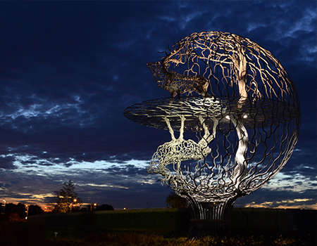 outdoor wildlife sculpture illuminated with spotlights